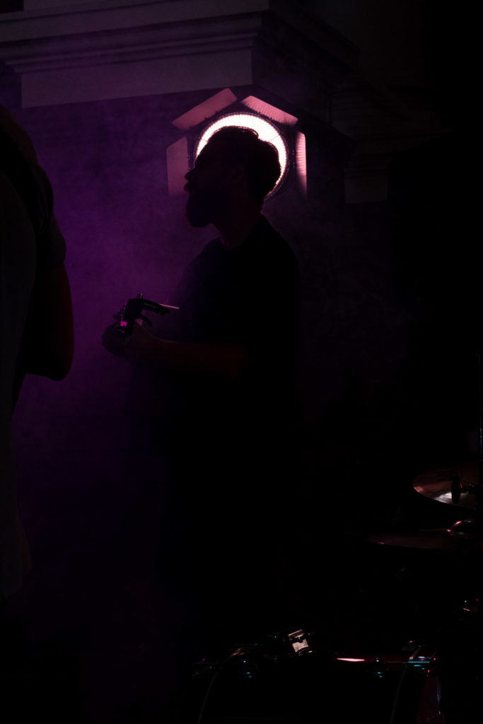 Bridges lead singer/guitarist silhouette against pink filtered Rotolight Aeos. Wex event, Spitalfields church.